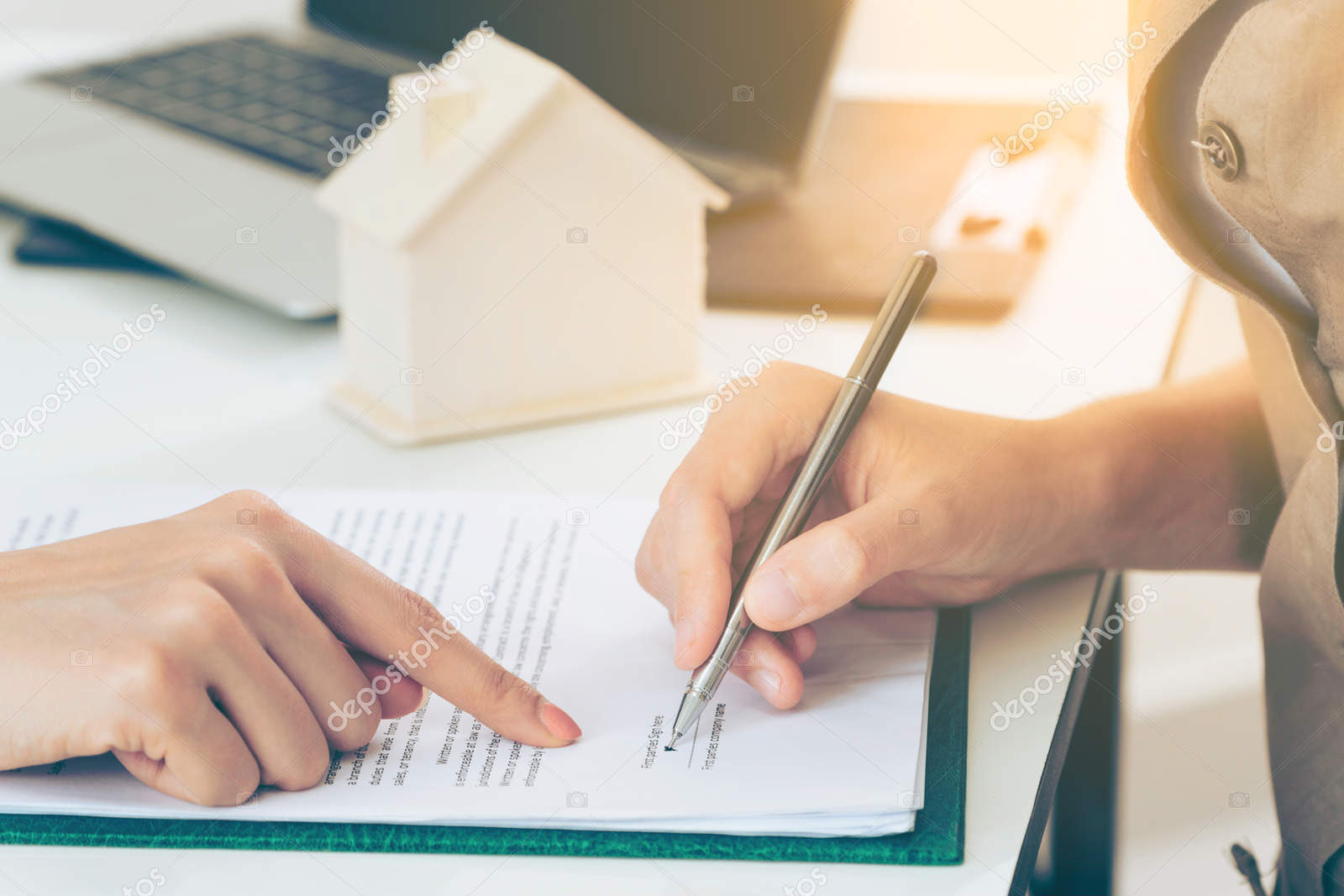 Client Signs Document to Buy House and Real Estate